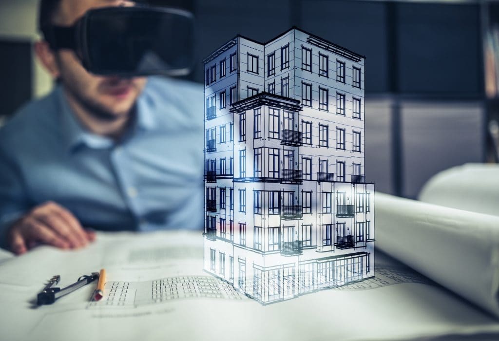 Male Architect wearing augmented reality headsets looking at the virtual model of his project